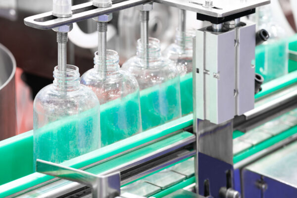 pharmaceutical industry, medicine pills are filling in the plastic bottle on production line machine conveyor at the medical factory. selective focus.